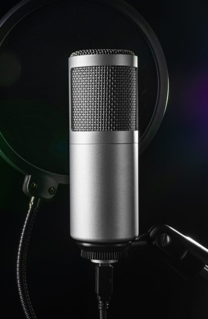 A silver microphone with a black dot on the side.